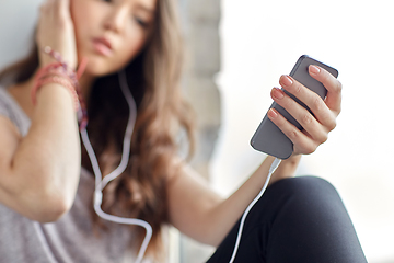 Image showing teenage girl with smartphone and earphones