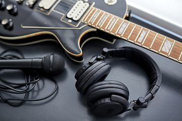 Image showing close up of bass guitar, microphone and headphones