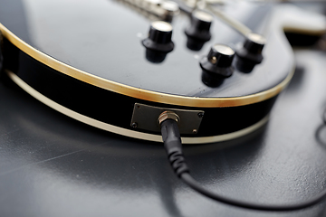 Image showing close up of bass guitar with plug