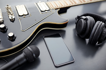 Image showing close up of bass guitar and smartphone