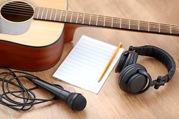 Image showing guitar, music book, microphone and headphones