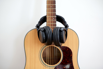 Image showing close up of acoustic guitar and headphones