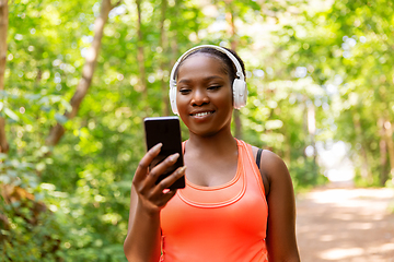 Image showing african american woman with headphones and phone