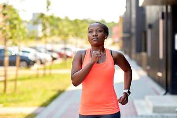 Image showing african woman with smart watch running in city