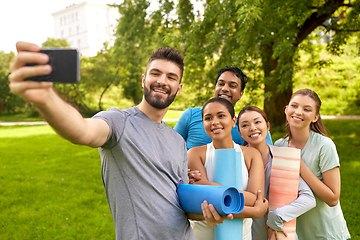 Image showing people with yoga mats taking selfie at park