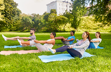 Image showing group of people doing yoga at summer park