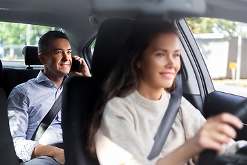 Image showing male passenger calling on phone in taxi car