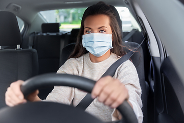 Image showing woman or female driver in mask driving car in city