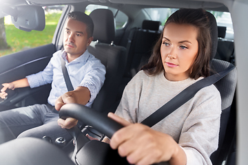 Image showing car driving school instructor teaching woman