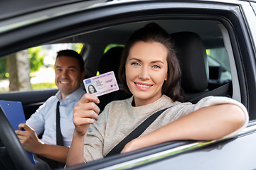 Image showing car driving instructor and driver with license