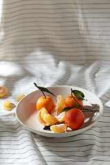 Image showing still life with mandarins on plate over drapery