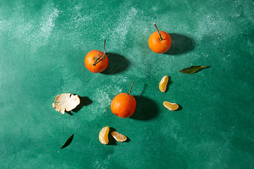 Image showing still life with mandarins on green background