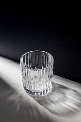 Image showing empty faceted glass on table