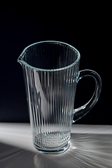 Image showing empty faceted glass jug on table