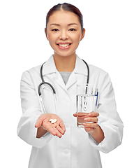 Image showing asian doctor with medicine and glass of water