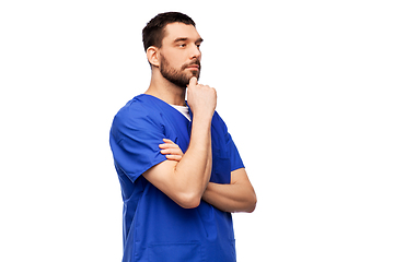 Image showing thinking doctor or male nurse in blue uniform