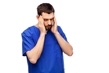 Image showing stressed doctor or male nurse in blue uniform