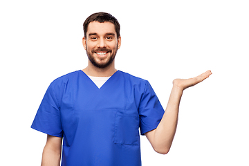Image showing smiling male doctor holding something on hand