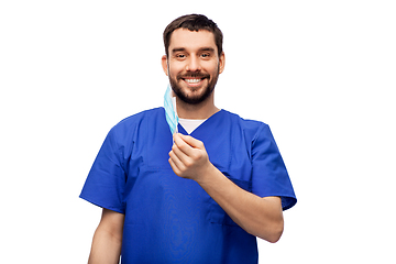 Image showing smiling male doctor in blue uniform with mask