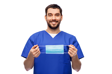 Image showing smiling male doctor in blue uniform with mask