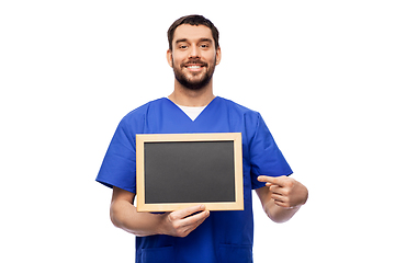 Image showing happy smiling male doctor or nurse with chalkboard