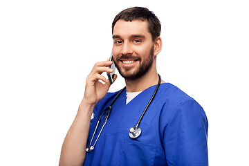 Image showing smiling doctor or male nurse calling on smartphone