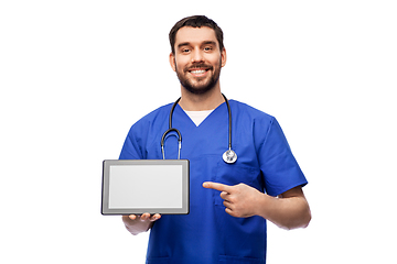 Image showing happy doctor or male nurse showing tablet computer