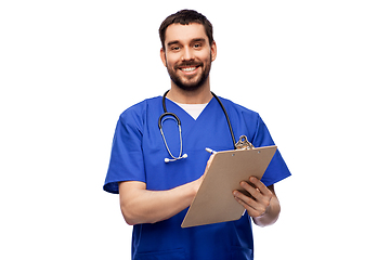 Image showing male doctor writing medical report on clipboard