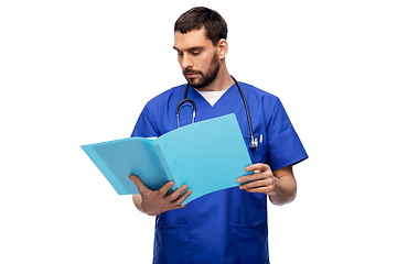 Image showing male doctor reading medical report in folder