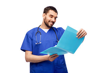 Image showing happy male doctor reading medical report in folder