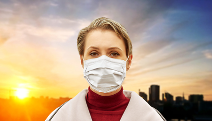 Image showing young woman wearing protective medical mask