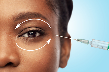 Image showing close up of face of african woman and syringe