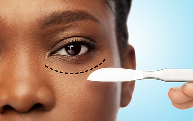 Image showing face of african american woman and scalpel knife