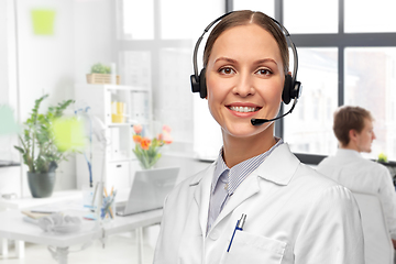 Image showing smiling female doctor with headset at hospital