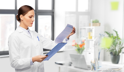 Image showing female doctor with medical report at hospital