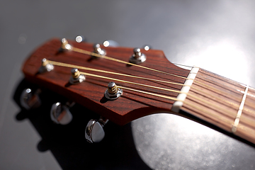 Image showing close up of acoustic guitar head with pegs