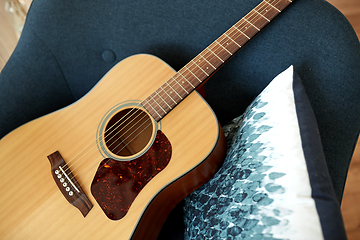 Image showing close up of acoustic guitar on armchair