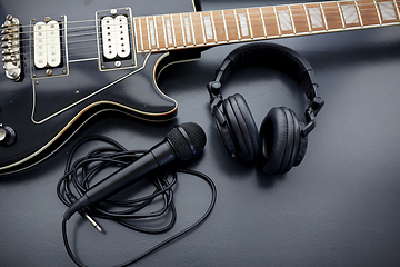 Image showing close up of bass guitar, microphone and headphones