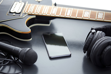 Image showing close up of bass guitar and smartphone