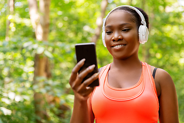 Image showing african american woman with headphones and phone
