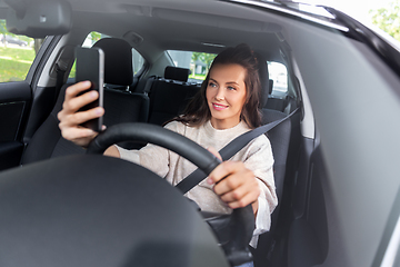 Image showing woman or driver driving car and taking selfie