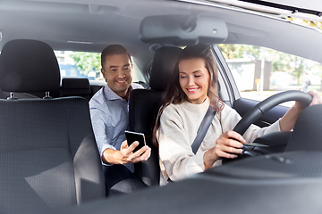 Image showing female driver driving car with male passenger