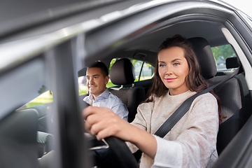 Image showing woman and driving school instructor in car