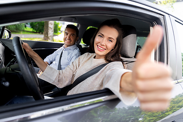 Image showing car driving instructor and woman showing thumbs up