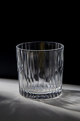 Image showing empty faceted glass on table