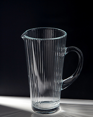 Image showing empty faceted glass jug on table