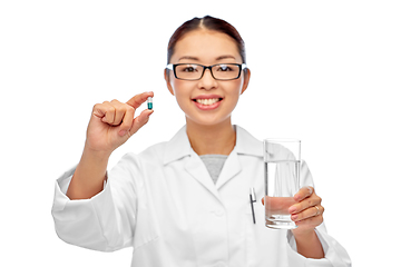 Image showing asian doctor with medicine and glass of water