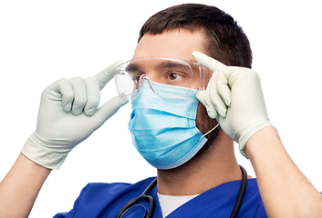 Image showing male doctor in goggles, mask and gloves