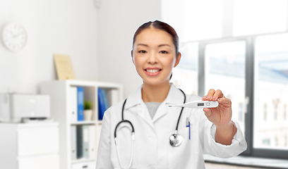 Image showing smiling asian female doctor with thermometer