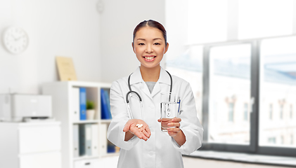 Image showing asian doctor with medicine and glass of water